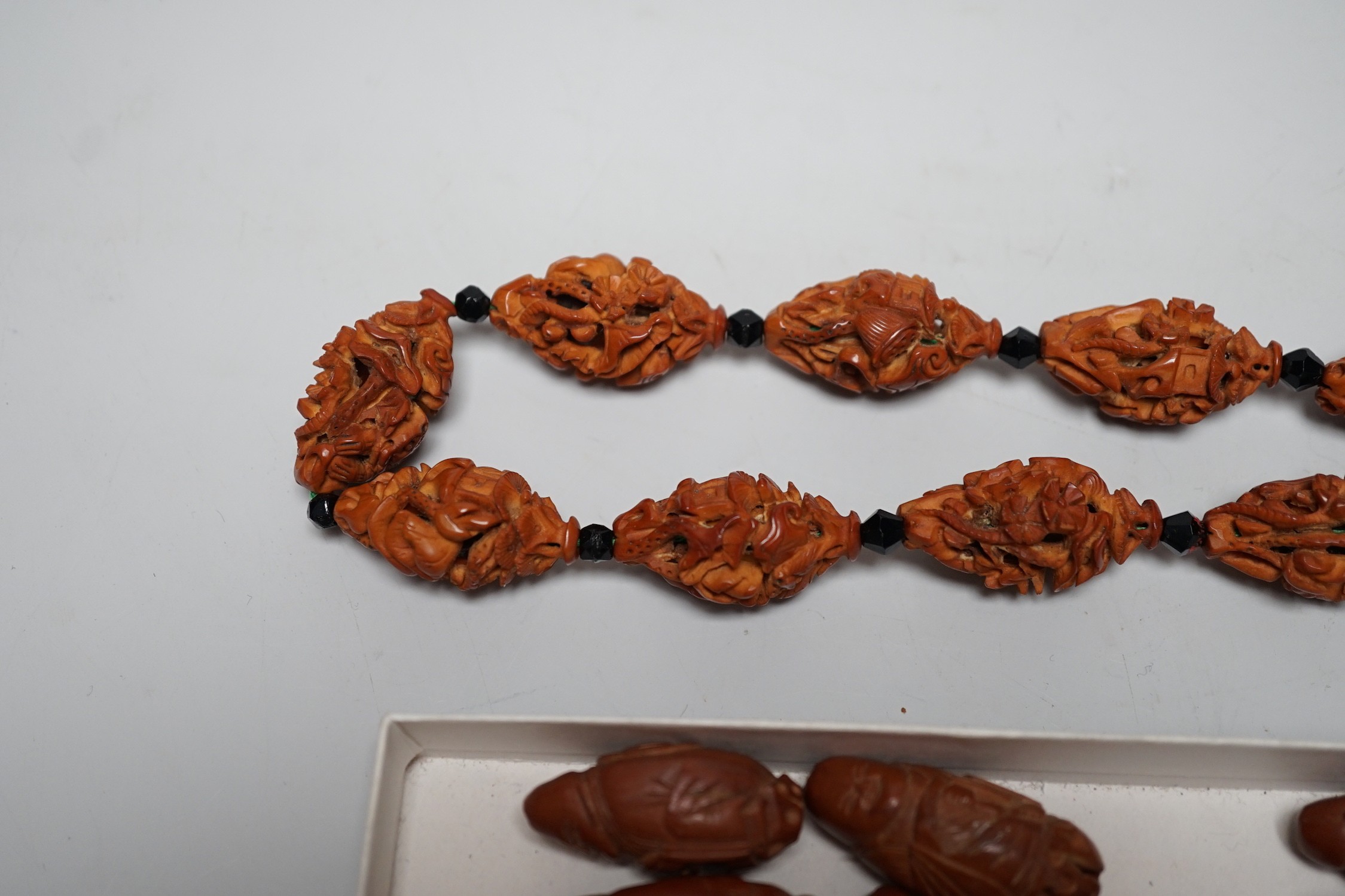 A collection of Chinese carved peach stones, early 20th century